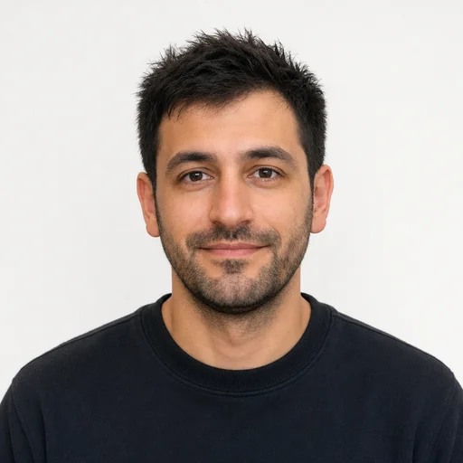 Centered passport-style portrait of the selected person in a dark sweater with a plain light background.
